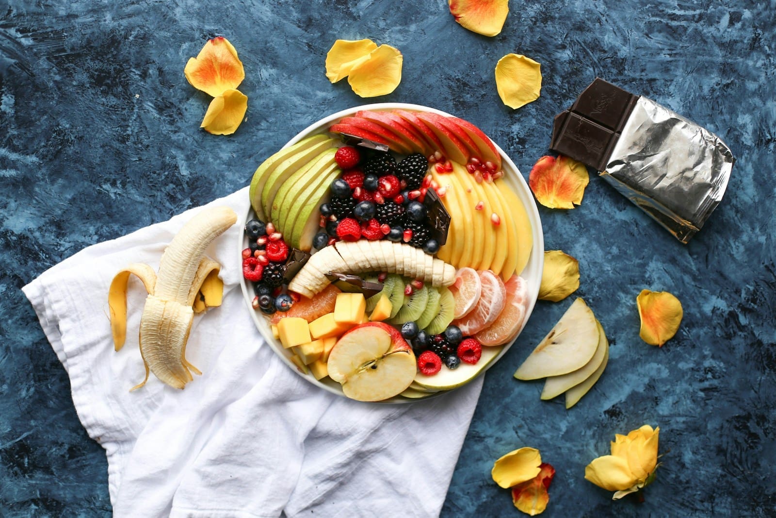 Photo by Brenda Godinez bowl of sliced fruits on white textile