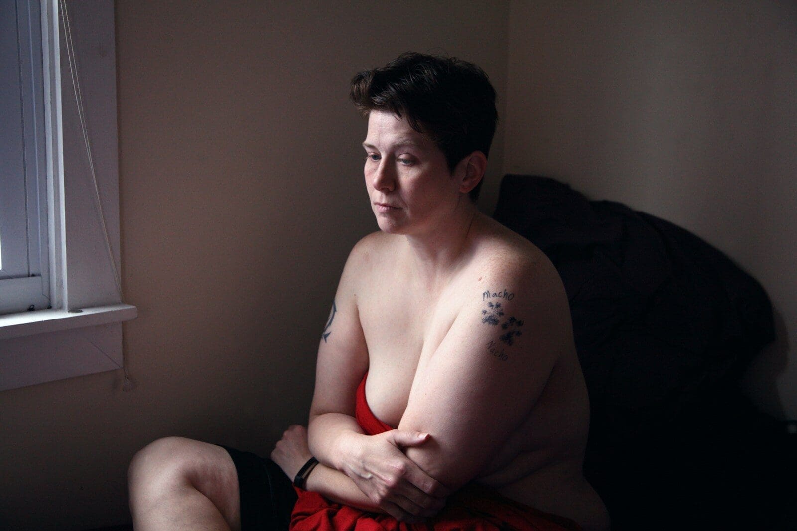 Photo by Shane topless woman with shirt hair sitting on bed. PCOS symptoms can be brutal